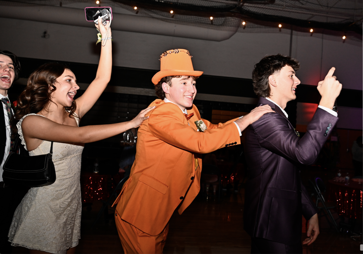 Having fun, seniors Caitlin Wiseman, Brody Featherston and Carter Cox start the conga line while enjoying the sweetheart dance.